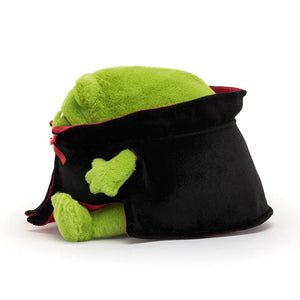 Side: Soft Jellycat Vampire Ricky Rain Frog (side view) with cape & embroidered fangs. Adorable Halloween cuddle toy.