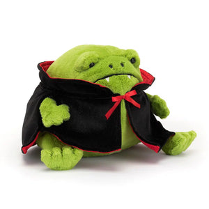 Angled: Jellycat Vampire Ricky Rain Frog (angled view) with cape, fangs & embroidered eyes. Spooky cute Halloween plush.