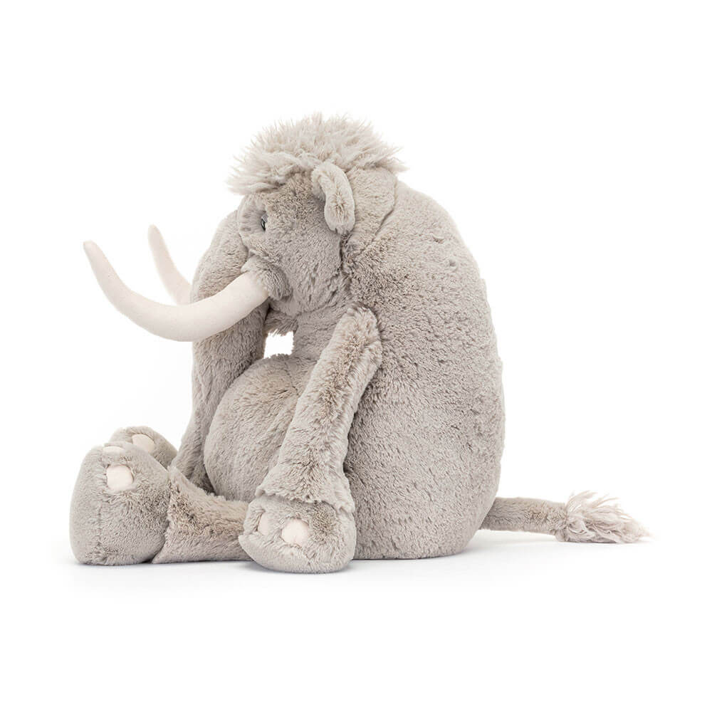Side view of Jellycat Viggo Mammoth showcasing its fluffy fur and large tusks.