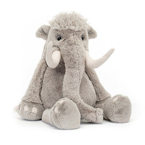 Angled View: Jellycat Vigo Mammoth, showcasing his soft, warm grey fur, especially on his squidgy tummy. A fleecy hairdo, rumpled ears, and a wiggly trunk. Suedette nails hint at his prehistoric past.