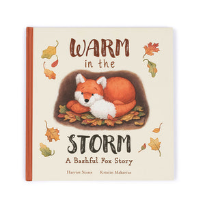 Straight On View: Front view of the engaging Jellycat Warm in the Storm book. Features a colorful cover illustration of Rusty Fox's cozy den.