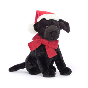 Angled: Jellycat Winter Warmer Pippa Lab (angled view): Black Labrador plush with red bow, fleece hat & wagging tail.