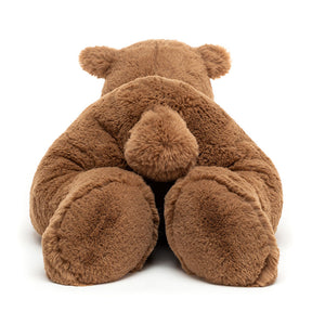 Back View: The epitome of cuddly comfort! Jellycat Woody Bear Lying (47 cm x 19 cm). Super soft fur, a tiny tail, and a relaxed pose make this teddy bear a huggable friend for all ages.