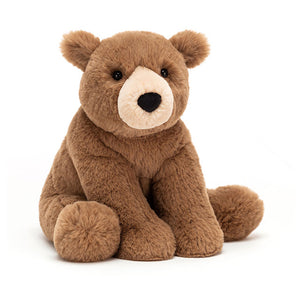 Angled View: Playtime buddy alert! Woody Bear (26 cm x 15 cm). This soft chocolate teddy bear features a friendly face, chunky paws, and is perfect for cuddles and adventures!