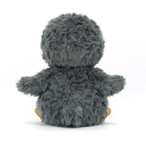 A back view of the Jellycat Yummy Penguin, highlighting its soft, white fur and the embroidered tummy.