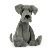 Angled View: Looking for a leggy pal? The Jellycat Zeus Great Dane leans in, showcasing his plush blue-grey fur with a friendly expression. Standout brows, floppy ears, and a giant black nose for sniffing out adventures! A loyal friend in a big package.