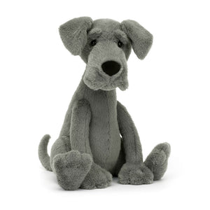 Angled View: Looking for a leggy pal? The Jellycat Zeus Great Dane leans in, showcasing his plush blue-grey fur with a friendly expression. Standout brows, floppy ears, and a giant black nose for sniffing out adventures! A loyal friend in a big package.
