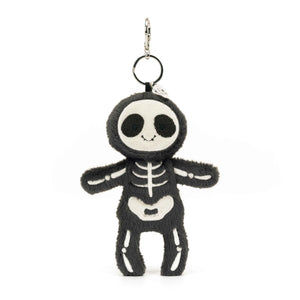 Straight: Jellycat Skeleton Bob bag charm (front view) with embroidered eyes & silver claw. Quirky bag decoration.