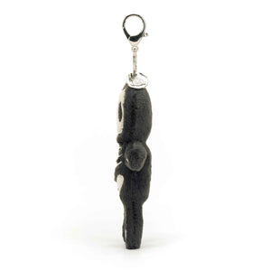 Side: Skeleton Bob bag charm (side view) with charcoal fur & embroidered bones. Cute Halloween bag charm.