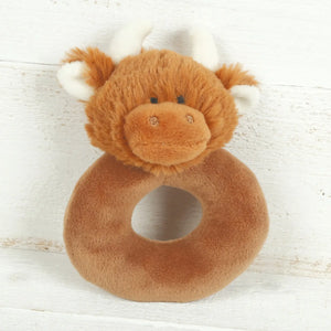Baby rattle with a plush fizzy body and in the shape of a Scottish Highland Cow.