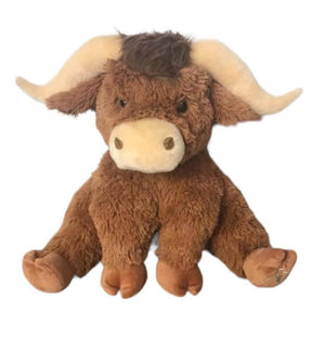 Children's soft toy highland cow covered in thick fluffy brown fun and with horns.