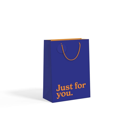 Navy blue medium gift bag with orange slogan text on white background.