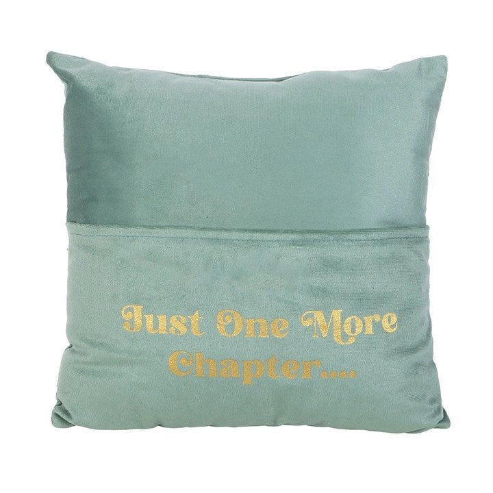 Cushion with gold lettering and pocket holding a book.