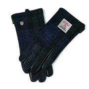 Ladies Harris Tweed gloves in classic Black Watch Tartan, featuring rich navy, green, and black tones with smooth leather trim and touchscreen fingertips — elegant and functional winter accessories handcrafted from genuine Harris Tweed®.