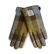 Front view of ladies gloves in Chestnut & Blue Harris Tweed® with brown leather trim and official Harris Tweed® label.