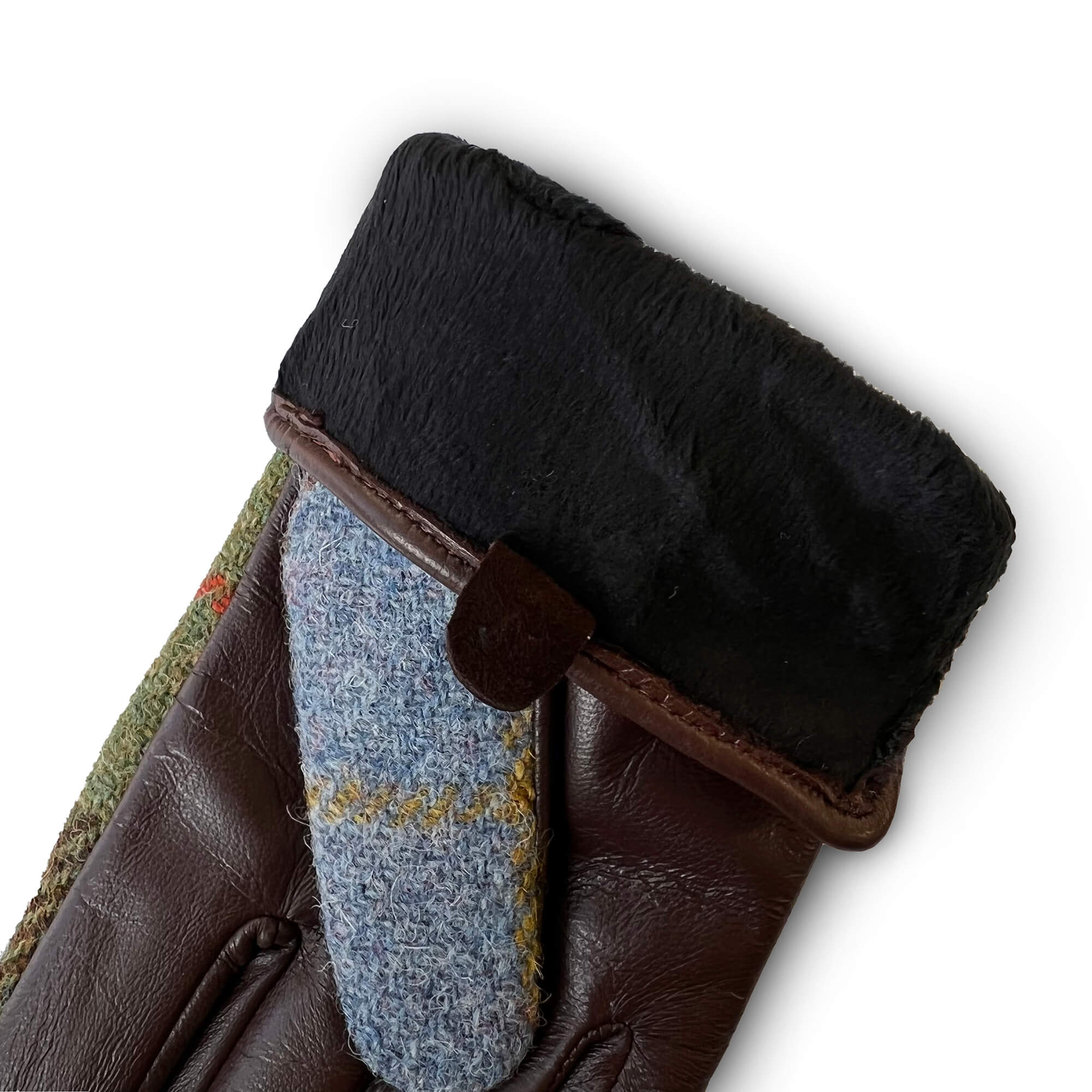 Interior shot of gloves showing black faux fur lining and Harris Tweed® fabric thumb detail in pale blue with yellow check.