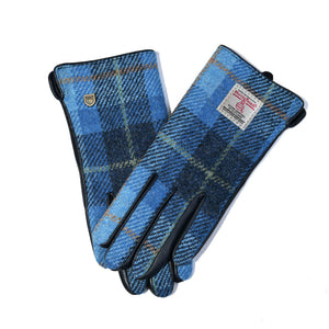 Front view of ladies gloves in vibrant Blue Tartan Harris Tweed® with black leather trim and official Harris Tweed® label.