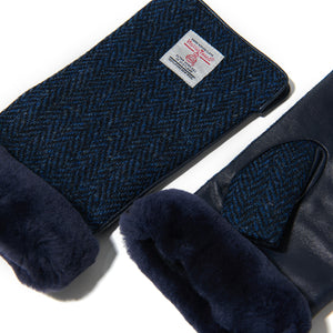 Angled: Ladies' Harris Tweed® & leather mittens (angled view) with Navy sheepskin cuffs in Navy Herringbone. Warm winter gloves.