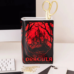 Dracula Large Book Vase used as a desktop organiser, holding gold scissors and paperclips.