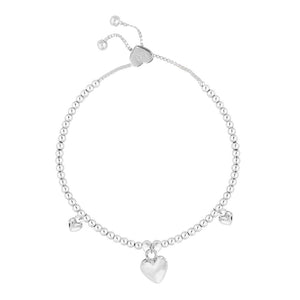 Close-up of Life Charms “I Love You Mum” adjustable silver bracelet with three puffed heart charms on silver-plated beads.