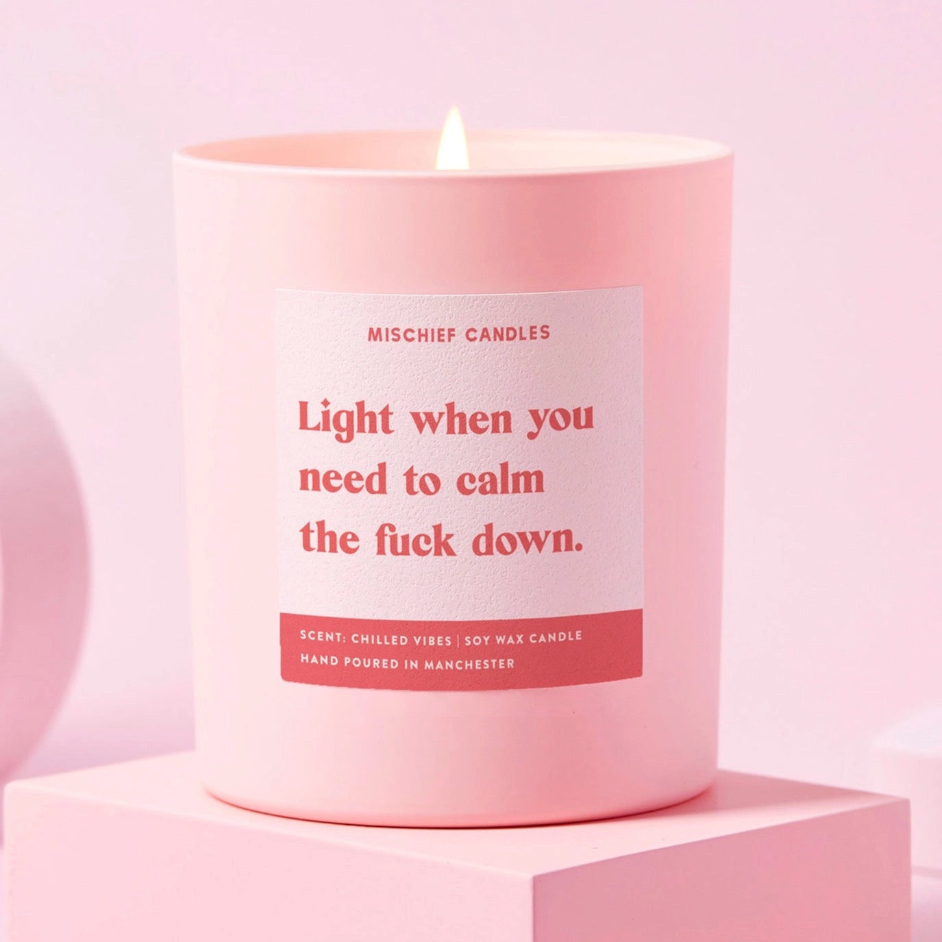 Pink soy wax candle with bold red text label reading “Light when you need to calm the f*ck down”, hand-poured in Manchester – Chilled Vibes scent.