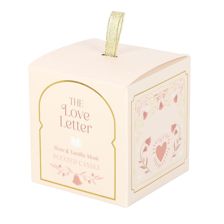 The Love Letter Rose & Vanilla Musk Candle gift box with floral and heart illustrations, gold detailing, and ribbon handle.