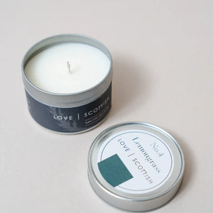 Lemongrass scented tin candle by Love Scottish, lid off, showing white coconut wax inside a sleek silver travel tin.