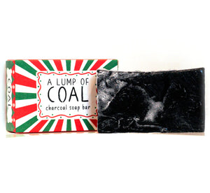 Charcoal Lump of Coal soap bar with festive red and green gift box reading A Lump of Coal.
