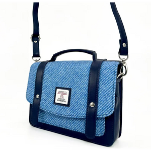 Compact Harris Tweed crossbody bag in sky blue herringbone with vegan leather trim.
