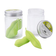Magic Cleaning Beans reusable bottle cleaning sponges in clear pot with metal lid, featuring two green sponge beans with ceramic cores for easy bottle cleaning.