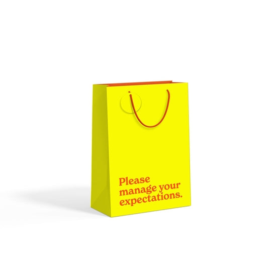 Yellow lime medium gift bag with red slogan text on white background.