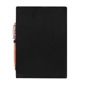 Back cover of black velvet manifestation journal with rose gold pen.
