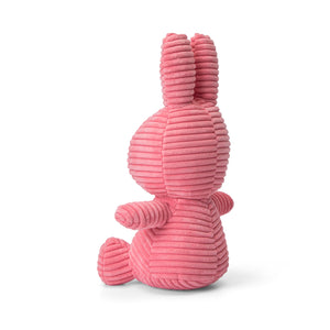 Side View: Sitting tall, Miffy bunny is a cuddly companion made from corduroy in a charming bubblegum pink shade.