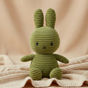Miffy corduroy olive green plush on cream blanket lifestyle shot