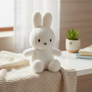 Miffy Cotton Candy cream plush on beige knitted blanket with succulent plant