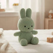 Miffy Cotton Candy pistachio green plush on white bedding in nursery setting