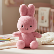 Miffy Cotton Candy rose pink plush on cream surface in nursery lifestyle setting