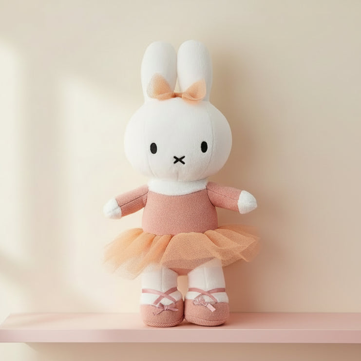 Miffy ballerina plush standing on pink shelf against cream wall