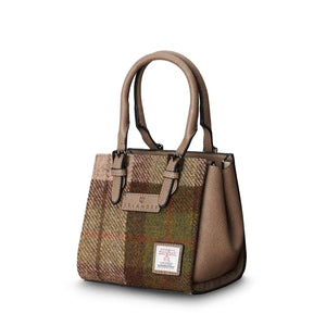 Islander Mini Caillie Tote in warm chestnut tartan Harris Tweed, viewed from the side with a folded silhouette.