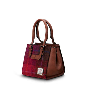 Islander Mini Caillie Tote in red tartan Harris Tweed, viewed from the side with a folded silhouette.