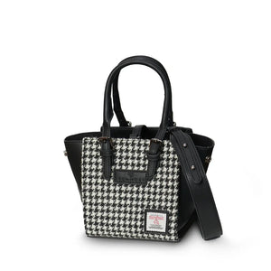 Black and white dogtooth Harris Tweed Mini Caillie Tote with structured sides, revealing a glimpse of the roomy interior.