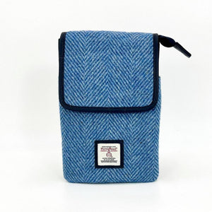 Sky blue Harris Tweed mini crossbody bag with flap front, herringbone weave and Harris Tweed label.