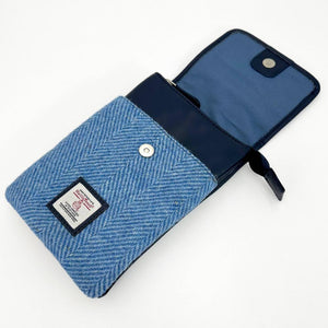 Interior of sky blue Harris Tweed mini bag showing dual compartments and magnetic snap closure under flap.