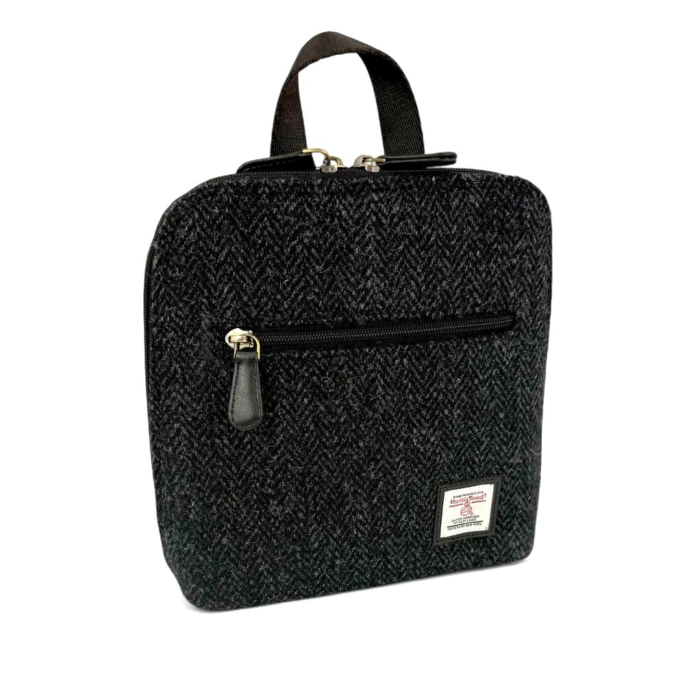 Charcoal Harris Tweed mini backpack front angled view on white background.