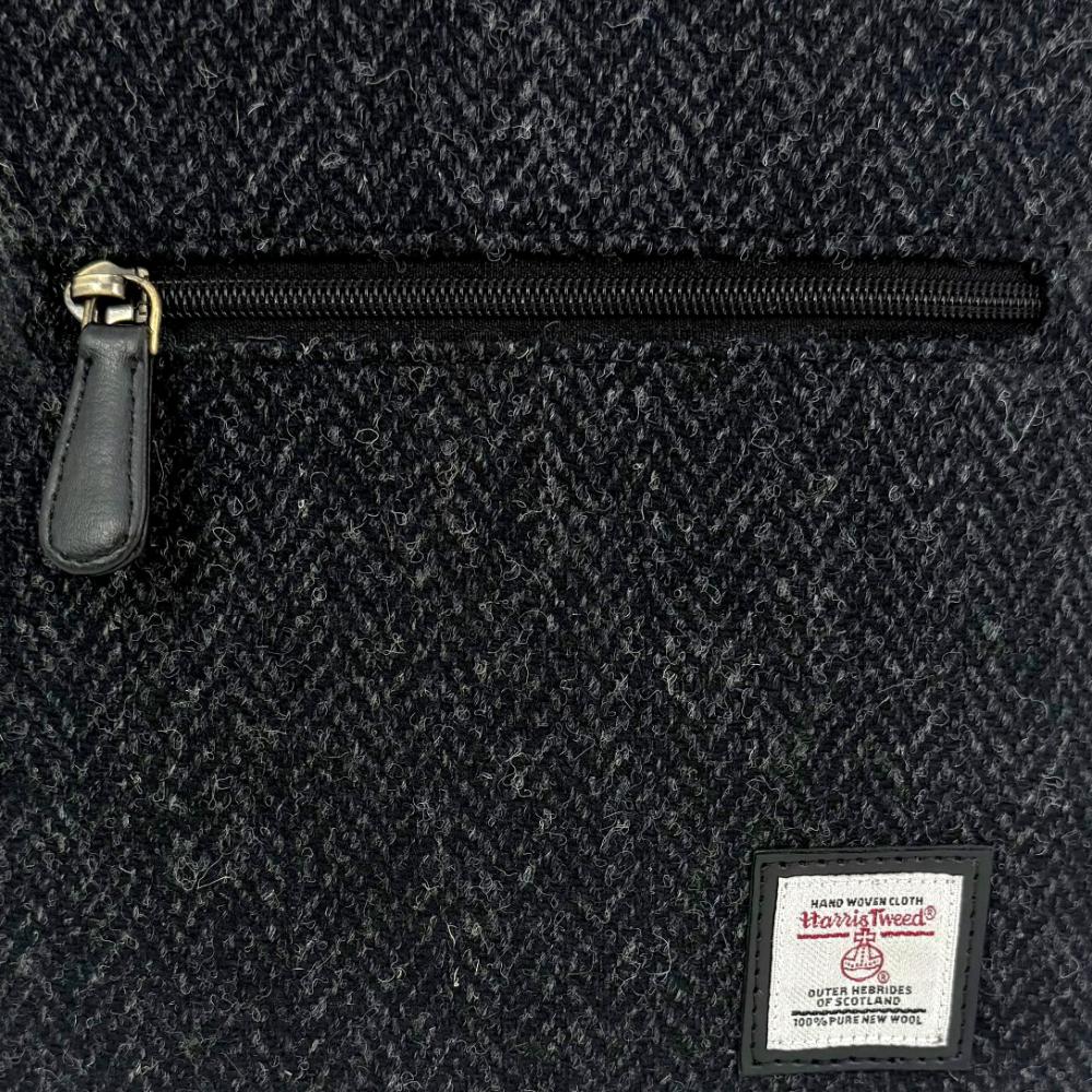 Close-up of charcoal Harris Tweed herringbone texture and label.