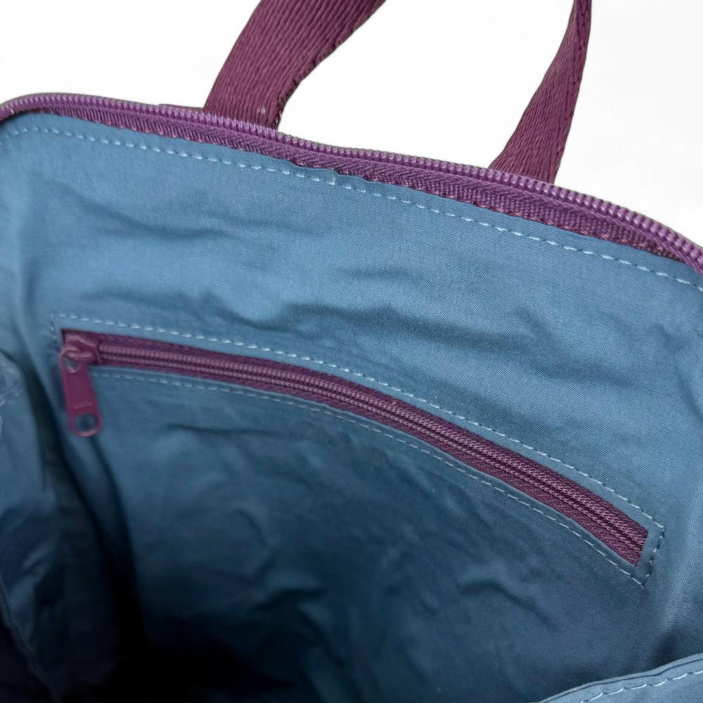 Green And Purple Plaid Harris Tweed mini backpack interior showing zip pocket and lining.