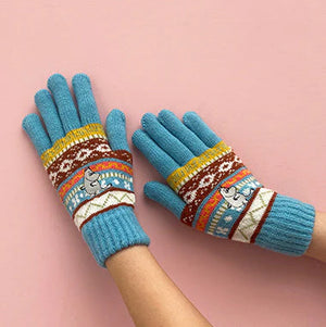 Pair of Moomin embroidered gloves worn with palms up.