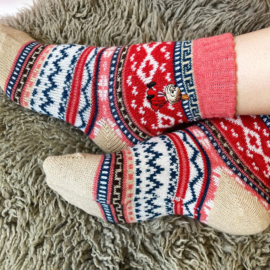 Close-up of Moomin Little My socks showing detailed red, white, and navy Fair Isle pattern with character embroidery near the ankle.