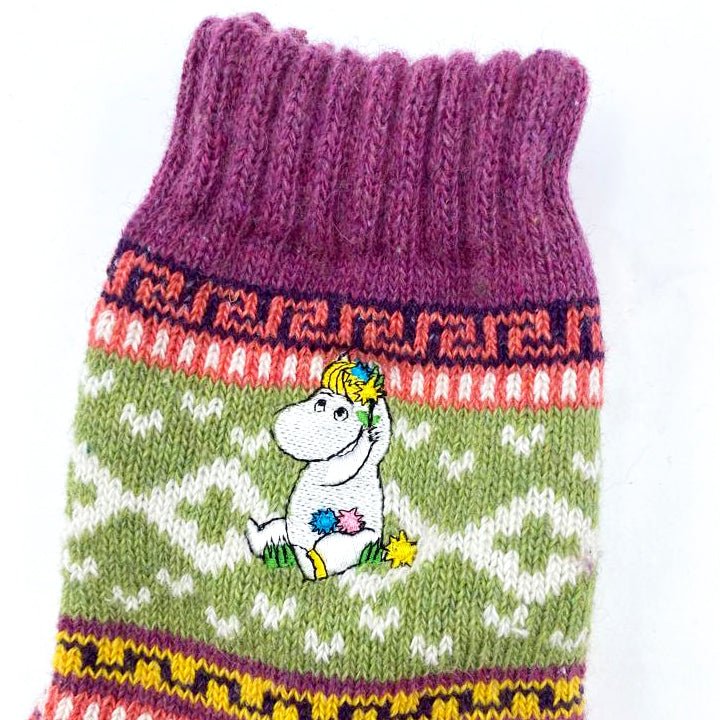 Close-up of Snorkmaiden embroidery on purple and green Fair Isle sock.