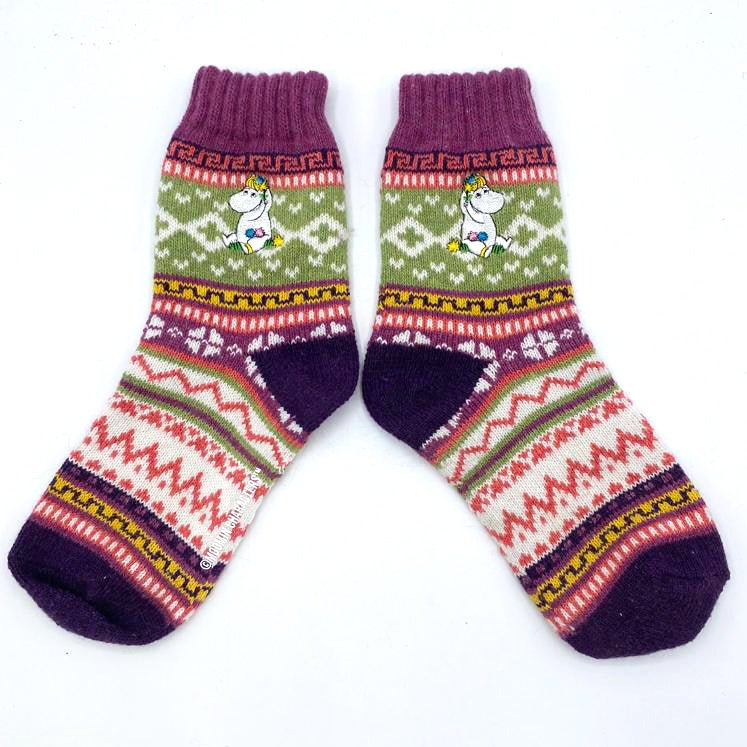 Flat lay of colourful Fair Isle Moomin Snorkmaiden socks on white background.